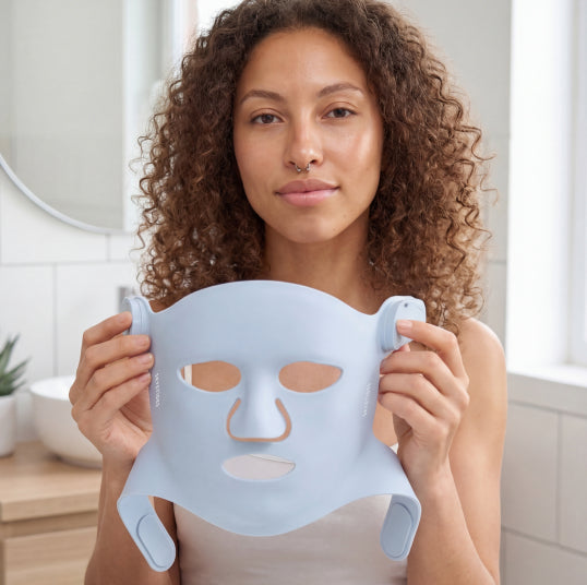 Placing LED light therapy mask evenly on the face before turning it on